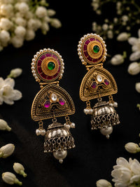 Angled view of Noorika traditional jhumka earrings with green stone and pearl border