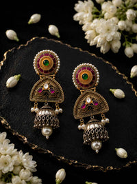 Noorika traditional Indian jhumka earrings arranged with jasmine garland on black velvet